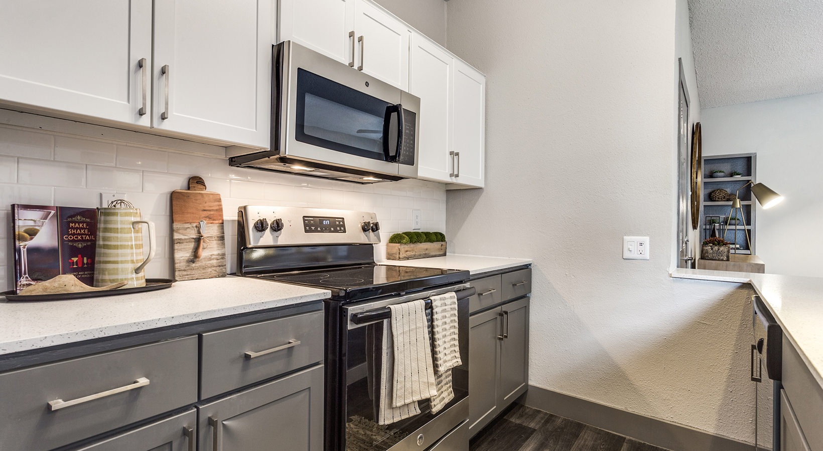 a kitchen with stainless steel appliances and a microwave at The Hyde Park at Valley Ranch